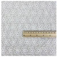 A square piece of Longan Craft White Floral Eyelet Embroidered Voile Fabric (100% cotton, hollow out embroidery) is shown with a ruler displaying both centimeters and inches for scale. Ideal for dressmaking and sewing projects.