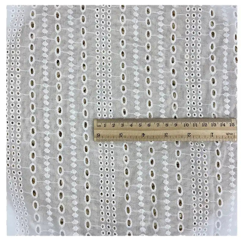 A piece of Longan Craft White Floral Eyelet Embroidered Voile Fabric (100% cotton), shown with a 20cm ruler for scale. This hollow out embroidery material is ideal for dressmaking and sold by the yard.