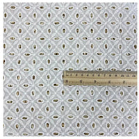 A sample of Longan Craft's White Floral Eyelet Embroidered Voile Fabric, 100% cotton with geometric circular and diamond embroidery, is shown next to a ruler for scale; the piece measures about 8 inches wide. Ideal for dressmaking.