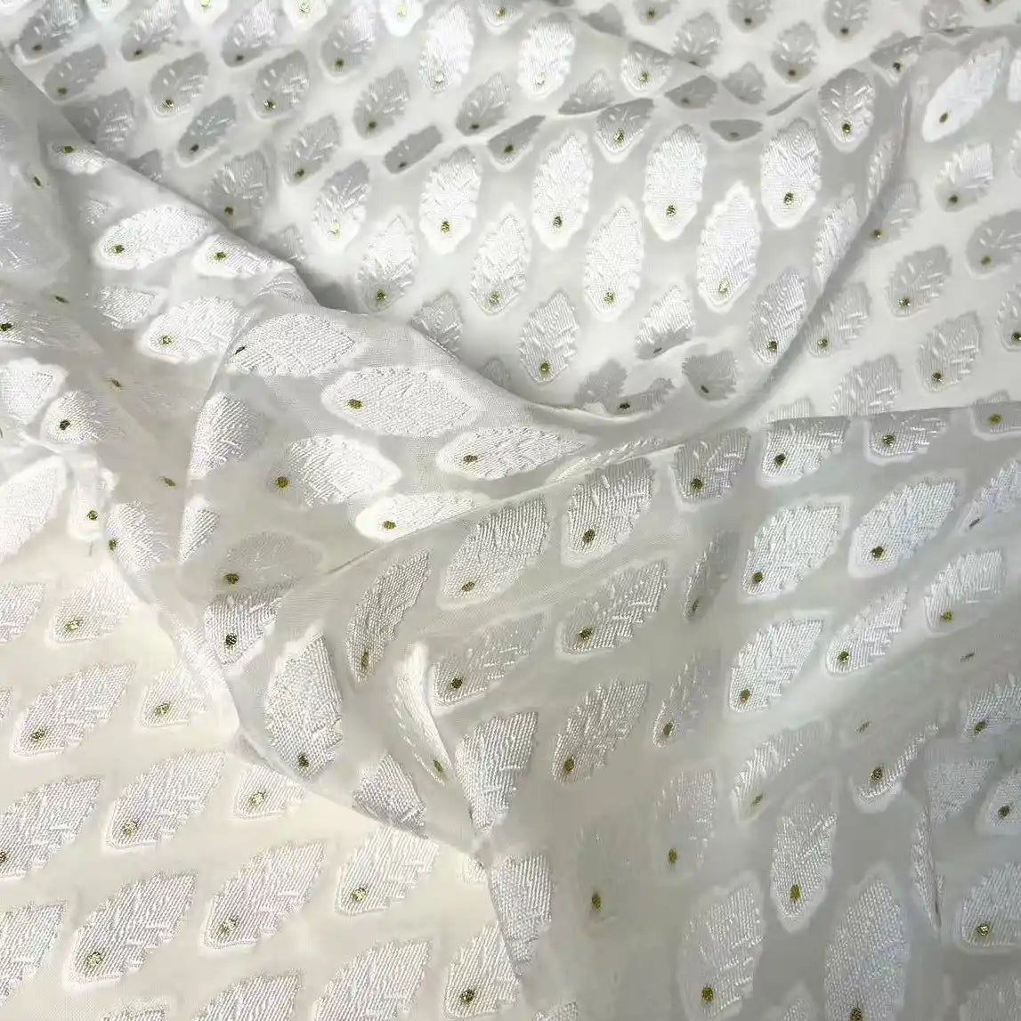 Longan Craft’s White Leaf Pattern Organza Fabric by the yard features a botanical jacquard design with delicate leaf motifs, perfect for clothing and decor. This softly draping material adds an elegant touch to any project.