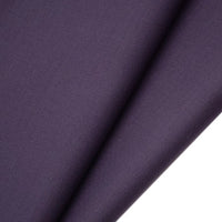 A close-up of Longan raft's Worsted Wool Gabardine Fabric By The Yard showcases its smooth, folded surface and fine twill texture, ideal for tailored suits with a colorful poly wool blend and subtle sheen.