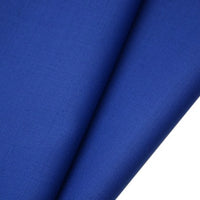 Close-up of two overlapping pieces of Longan raft Worsted Wool Gabardine Fabric By The Yard in vibrant royal blue, featuring a fine, slightly textured twill weave ideal for tailored suits.