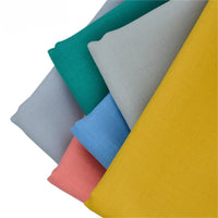 Five pieces of Longan raft Worsted Wool Gabardine Fabric in gray, green, blue, pink, and yellow are artfully fanned out on a white background. This colorful poly wool blended twill is ideal for durable, tailored suits.