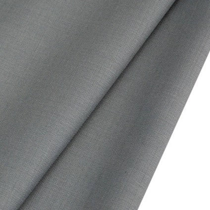 A close-up of Longan raft's Worsted Wool Gabardine Fabric By The Yard reveals its smooth, light grey, wrinkle-resistant poly wool blend twill—durable material ideal for tailored suits with a soft texture and clean finish.