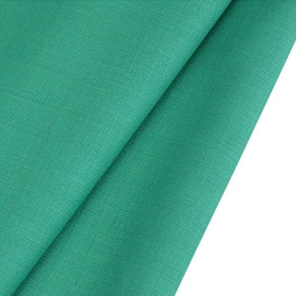 A close-up of Longan raft's Worsted Wool Gabardine Fabric by the yard, a colorful poly wool blended twill gabardine textile, displays its smooth texture and tightly woven, durable material ideal for tailored suits.