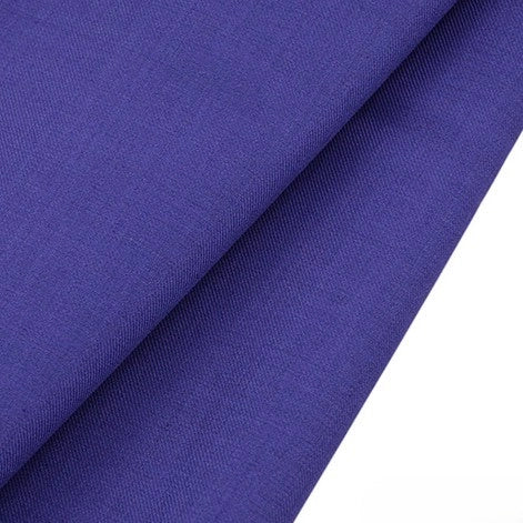 A close-up of two overlapping pieces of Longan raft Worsted Wool Gabardine in deep blue, a smooth, wrinkle-resistant poly wool twill fabric for tailored suits, shown against a white background.