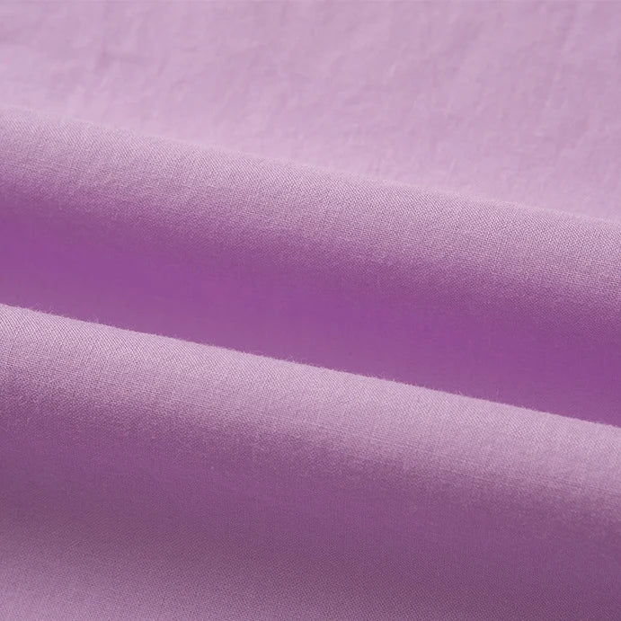 Close-up of Longan Craft’s Woven Lawn Fabric By The Yard, a soft multicolor cotton lawn material, folded to showcase its smooth texture and pastel purple shade—ideal as a lightweight cotton lawn lining.