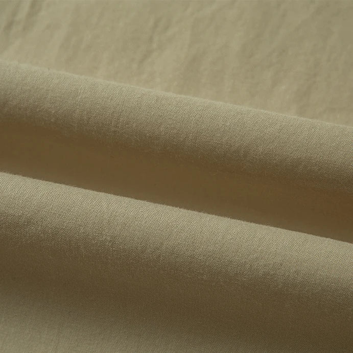 Close-up of Longan Craft’s Woven Lawn Fabric by the yard, a multicolor cotton lawn material with a soft, smooth texture. Gentle folds and subtle shadows highlight its natural weave—ideal as a cotton lawn lining for your projects.
