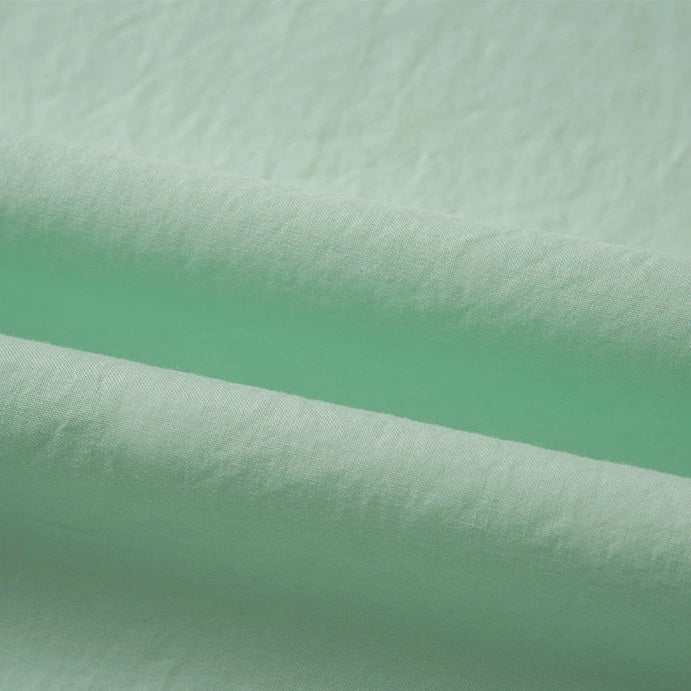 Close-up of Longan Craft’s multicolor woven cotton lawn fabric by the yard, showing soft folds and a gently textured surface for a smooth, airy appearance—ideal as a soft cotton lawn lining.