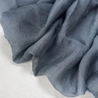 A close-up of Longan Craft’s Wrinkled Lyocell Fabric By The Yard showcases its soft, lightweight texture and breathable, sustainable solid color material—ideal for making tops.