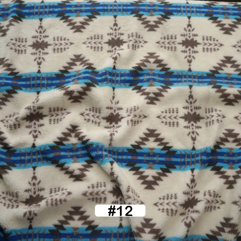 Longon Craft's Christmas Polar Fleece Fabric By The Yard features a geometric brown and blue zigzag and diamond print on white, with double-sided thick polyester, labeled #12 at the bottom center.