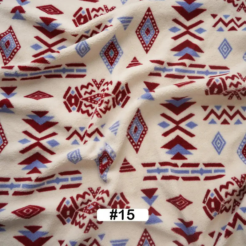The image shows crumpled Christmas Polar Fleece Fabric By The Yard by Longon Craft, featuring soft cream polyester with red and blue geometric patterns. A white label at the bottom center reads #15 in black text—ideal for cozy holiday sewing projects.