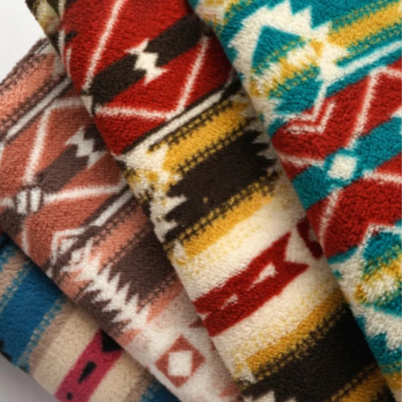Four vibrant, folded Longon Craft Christmas Polar Fleece Fabric by the yard, featuring bold tribal and geometric prints in red, turquoise, yellow, black, and beige—ideal for festive, cozy creations with double-sided, thick polyester material.