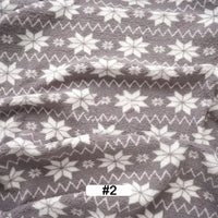 Add cozy holiday style with Longon Craft’s Christmas Polar Fleece Fabric By The Yard, a gray and white double-sided polyester fleece featuring snowflakes and zigzag lines—perfect for festive décor and sewing projects. White label at center reads “#2” in black.
