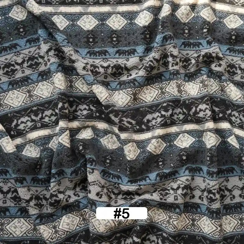 Longon Craft’s Christmas Polar Fleece Fabric by the yard features blue, black, white, and gray geometric and elephant patterns. This double-sided thick polyester fleece is shown wrinkled, with a “#5” label at the bottom center.