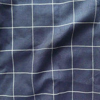 Navy blue fabric with white grid pattern