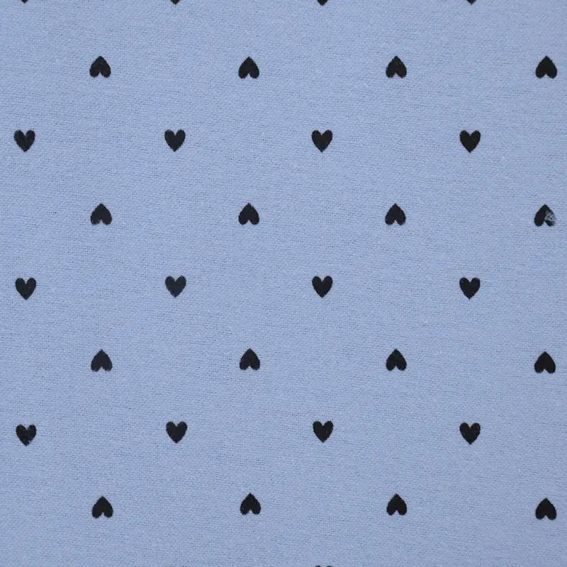 Pattern of black hearts on a light blue background