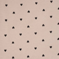Pattern of black hearts on a beige background