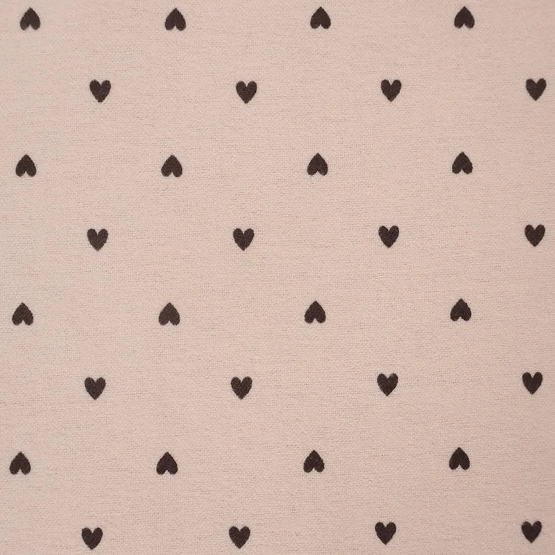 Pattern of small black hearts on a beige background