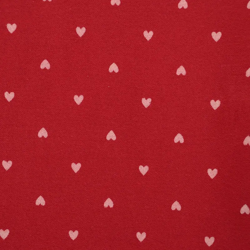 Red fabric with small white heart patterns