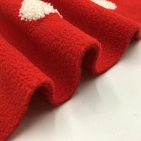 Close-up of Longon Craft's Heart Polar Fleece Fabric By The Yard, a red polyester material with 3D white heart patterns and wavy edges, appearing soft and fuzzy on a white background—ideal for sewing and crafts.