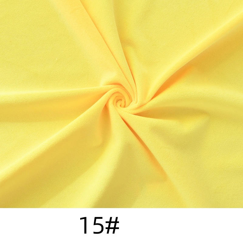 A yellow spiral-twisted piece of Longon Craft Minky Fabric By The Yard, Solid Color Thick Cuddle Minky, soft polyester for plushies and upholstery, with “15#” below.