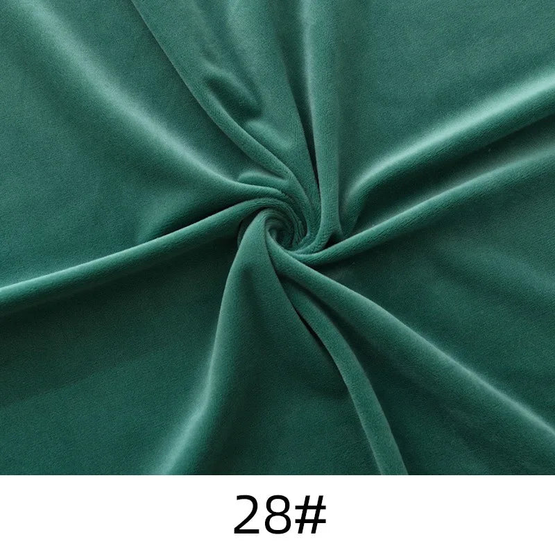Longon Craft's Solid Color Thick Cuddle Minky Fabric by the yard features plush green polyester in a spiral pattern, labeled "28#", ideal for hypoallergenic baby blankets, soft dolls, plushies, crafts, or upholstery projects.