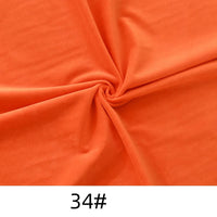 Longon Craft's Solid Color Thick Cuddle Minky Fabric, a soft orange plush polyester for dolls and crafts, is twisted at the center and marked "34#" at the bottom.