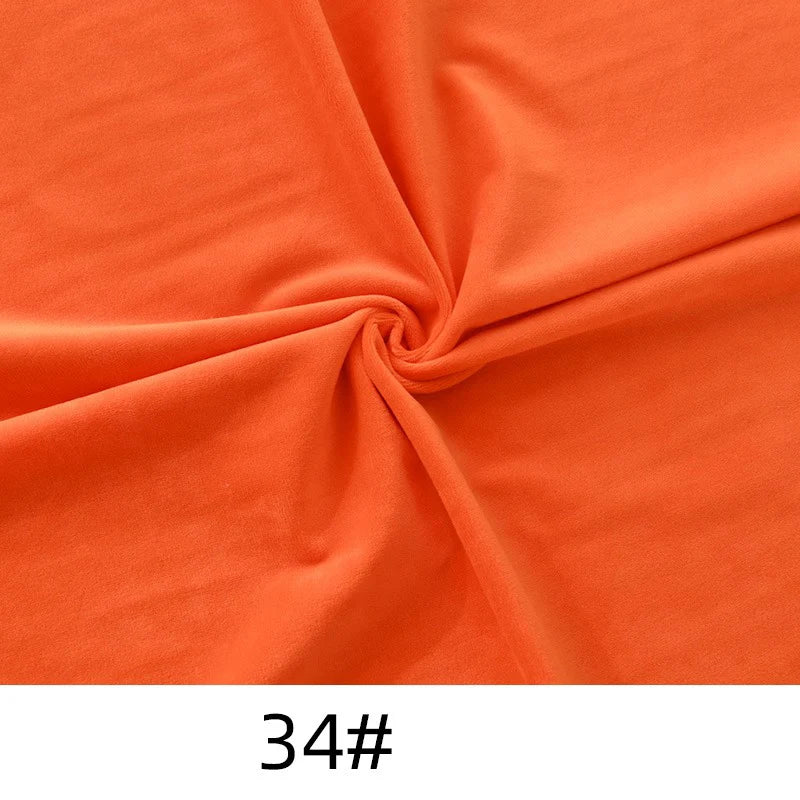 Longon Craft's Solid Color Thick Cuddle Minky Fabric, a soft orange plush polyester for dolls and crafts, is twisted at the center and marked "34#" at the bottom.