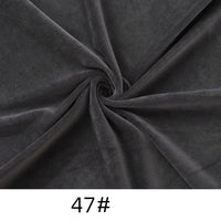 Close-up of Longon Craft Minky Fabric by the Yard in dark gray, arranged in a spiral pattern. This soft, thick cuddle upholstery material is perfect for plushies, dolls, and crafts. Solid color 47# shown below.