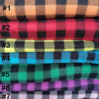 Seven folded pieces of Longon Craft Plaid Polar Fleece Fabric By The Yard, 100% polyester in orange, red, yellow, blue, green, purple, and pink—perfect patterned fabric for DIY sewing or crafts.