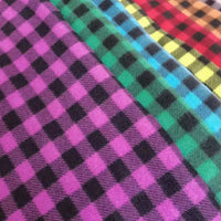Close-up of Longon Craft Plaid Polar Fleece Fabric By The Yard—100% polyester with vibrant diagonal checks in purple, green, blue, yellow, and red. Perfect for cozy DIY sewing projects; available as patterned printed polar fleece.