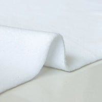 A close-up of Longon Craft Plain Polar Fleece Fabric by the yard shows its smooth, thick, anti-pill polyester surface and slight stretch, with a lifted edge highlighting its texture and quality against a neutral background.