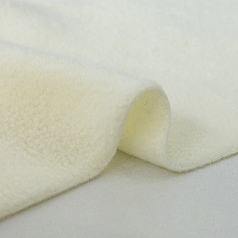 Close-up of Longon Craft's Plain Polar Fleece Fabric By The Yard—thick, anti-pill polyester fleece with a soft, fluffy texture—shown folded on a smooth white background. Perfect stretch material for sewing jackets and outdoor wear.