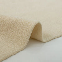 A close-up of Longon Craft's Plain Polar Fleece Fabric by the yard shows its thick, anti-pill beige polyester with a soft, textured surface and gentle folds. The background is plain white.