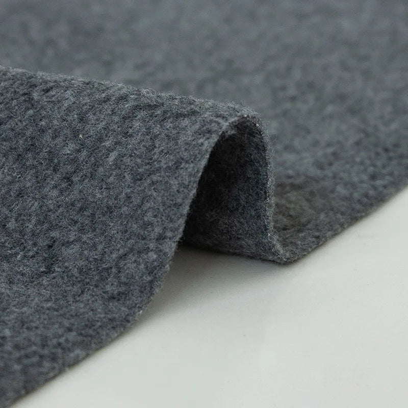 A close-up of Longon Craft Plain Polar Fleece Fabric by the Yard shows the thick, soft, anti-pill polyester's textured surface and curled edge on a light background—ideal for stretch sewing projects.