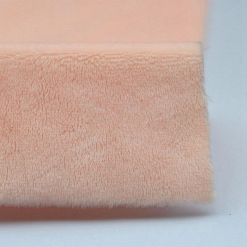A close-up of Longon Craft Plush Minky Fabric By The Yard in a peach solid color, crafted from ultra-soft 5mm polyester minky material, ideal for plushies and sewing crafts, shown folded against a plain background.