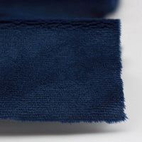 Close-up of Longon Craft Plush Minky Fabric by the Yard, a dark blue 5mm ultra-soft polyester material with a slightly frayed edge, shown on a light background; perfect for plushies, sewing, and crafts.