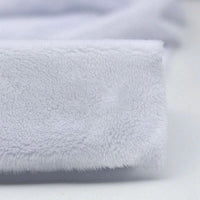 Close-up of Longon Craft’s Plush Minky Fabric By The Yard—5mm soft polyester in solid white, featuring a fuzzy texture on a plain surface. Ideal for plushies, cozy baby blankets, sewing, and craft projects.