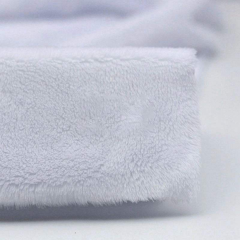 Close-up of Longon Craft’s Plush Minky Fabric By The Yard—5mm soft polyester in solid white, featuring a fuzzy texture on a plain surface. Ideal for plushies, cozy baby blankets, sewing, and craft projects.