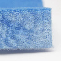 Close-up of the corner of Longon Craft's Plush Minky Fabric By The Yard, a soft, blue 5mm polyester minky material ideal for plushies, sewing, and crafts, shown against a white background.