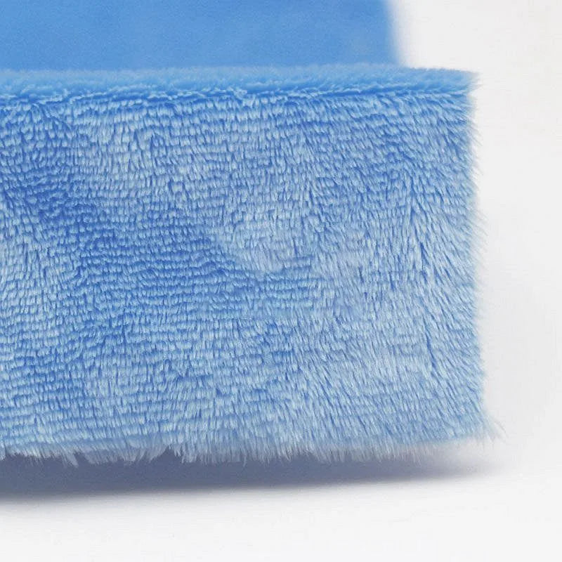 Close-up of the corner of Longon Craft's Plush Minky Fabric By The Yard, a soft, blue 5mm polyester minky material ideal for plushies, sewing, and crafts, shown against a white background.