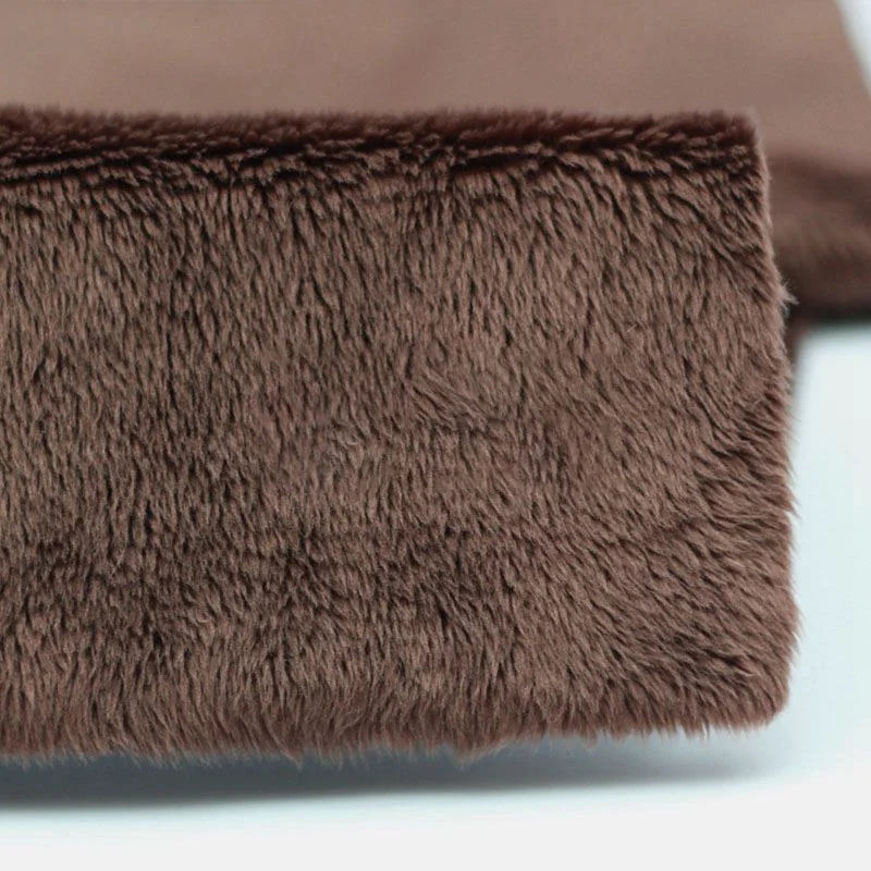 Close-up of a folded piece of Longon Craft Plush Minky Fabric By The Yard, a 5mm ultra-soft solid color polyester minky material ideal for plushies, sewing, and crafts, displayed on a white surface.