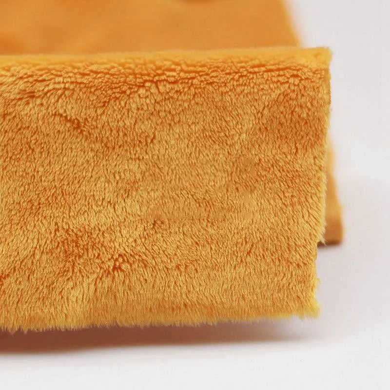 Close-up of Longon Craft's Plush Minky Fabric by the Yard—a 5mm soft polyester material in solid orange, showcasing its plush, fluffy texture. Ideal for plushies, sewing projects, or as cozy baby blanket fabric.
