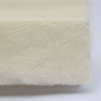 Close-up of a folded, cream-colored Plush Minky Fabric By The Yard from Longon Craft, made with ultra-soft 5mm polyester, ideal for plushies and sewing crafts.