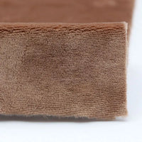 Close-up of the edge of Longon Craft Plush Minky Fabric by the Yard, a 5mm soft polyester material in solid brown, showing its textured surface resting on white—ideal for plushies, sewing, and crafts.