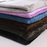 A neatly stacked pile of Longon Craft Plush Minky Fabric by the yard in solid colors—grey, purple, blue, brown, green, and black—features 5mm ultra-soft polyester ideal for plushies, sewing, and crafts.