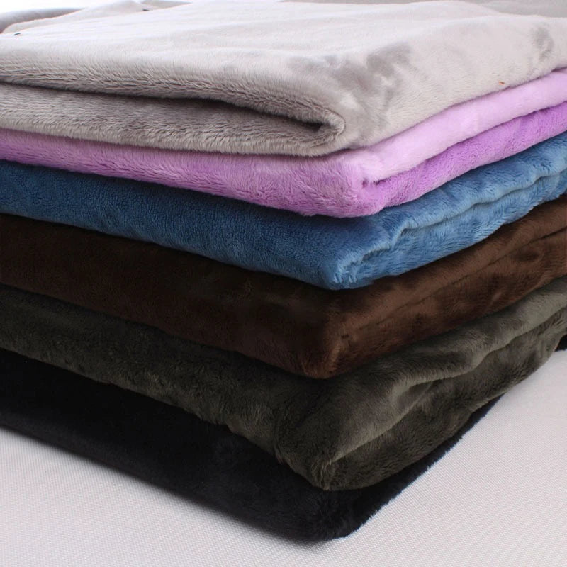 A neatly stacked pile of Longon Craft Plush Minky Fabric by the yard in solid colors—grey, purple, blue, brown, green, and black—features 5mm ultra-soft polyester ideal for plushies, sewing, and crafts.
