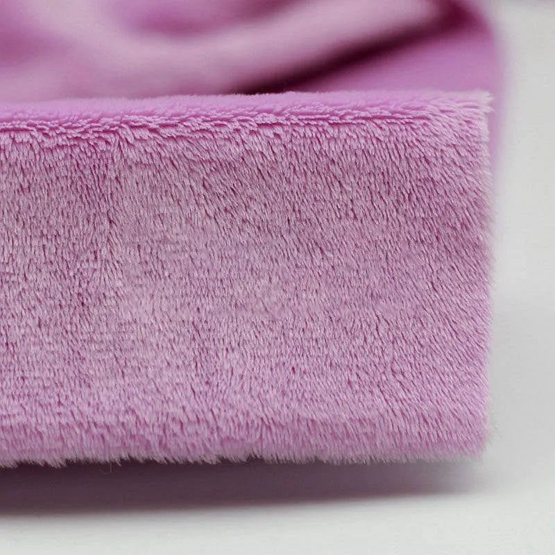 Close-up of Plush Minky Fabric By The Yard from Longon Craft—a soft, 5mm polyester minky in pink, ideal for plushies or baby blankets. Perfect solid color fabric for sewing and crafts.