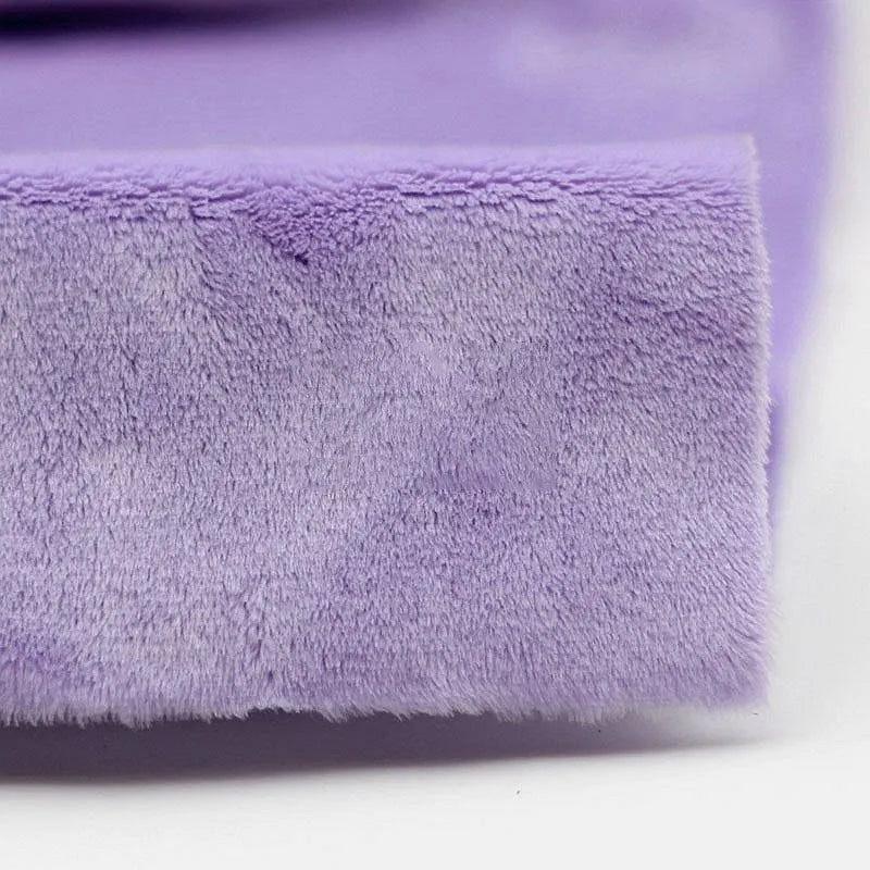 Close-up of Longon Craft’s Plush Minky Fabric By The Yard—5mm soft polyester minky in a solid purple color, featuring a slightly fuzzy texture and folded edge, perfect for plushies and sewing crafts.